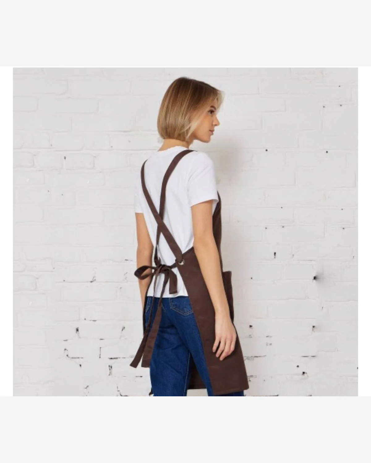Back view of brown workwear apron with cross-back straps and waist ties