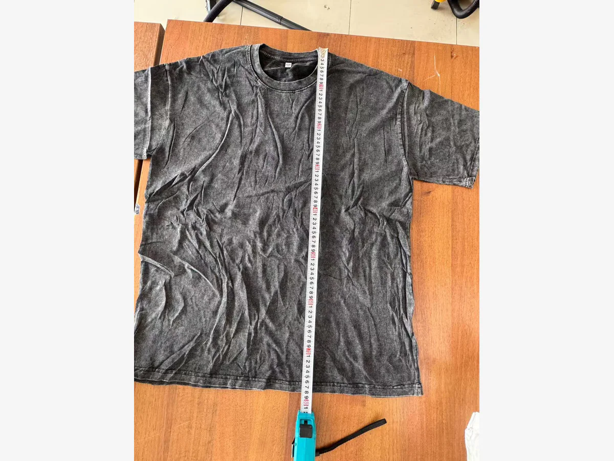Garment length measurement check for a vintage washed T-shirt sample
