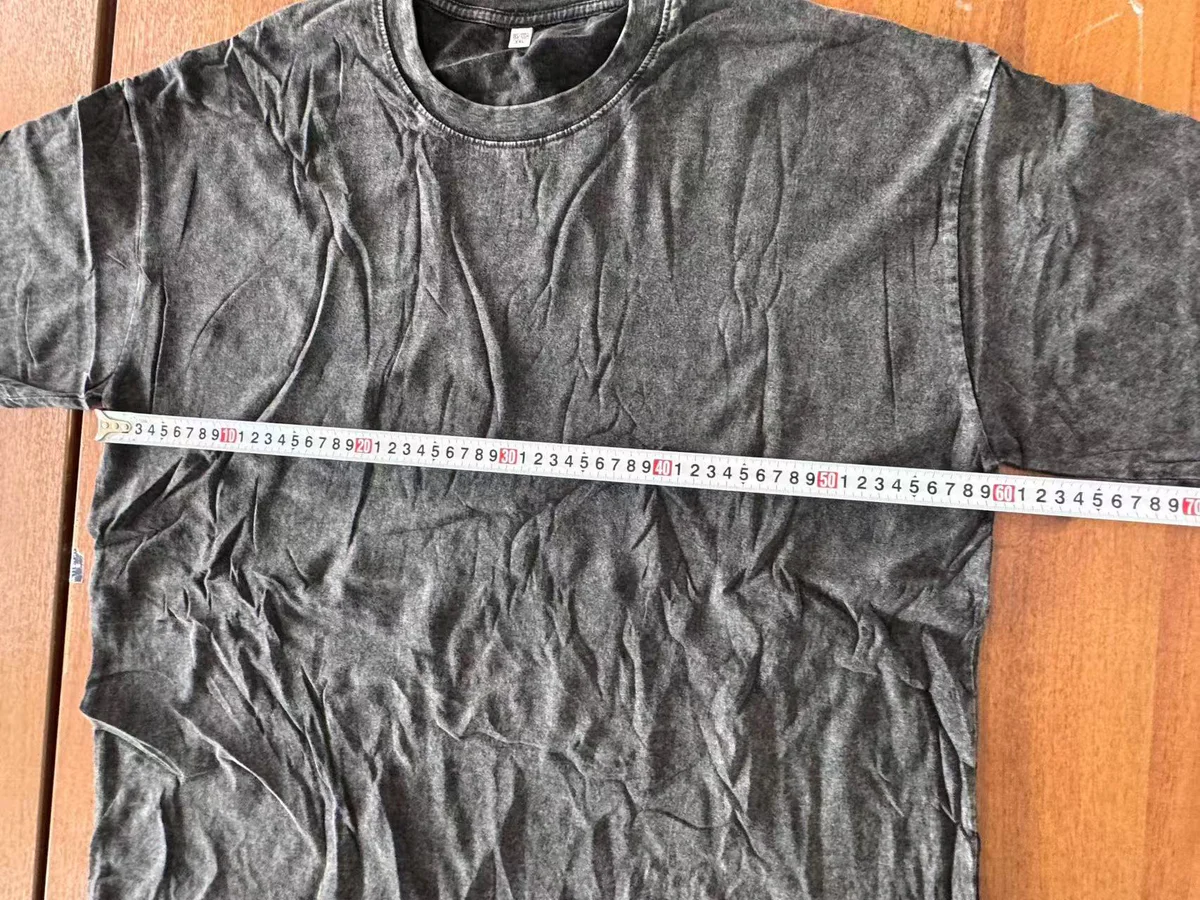 Flat garment width measurement check for a vintage washed T-shirt sample